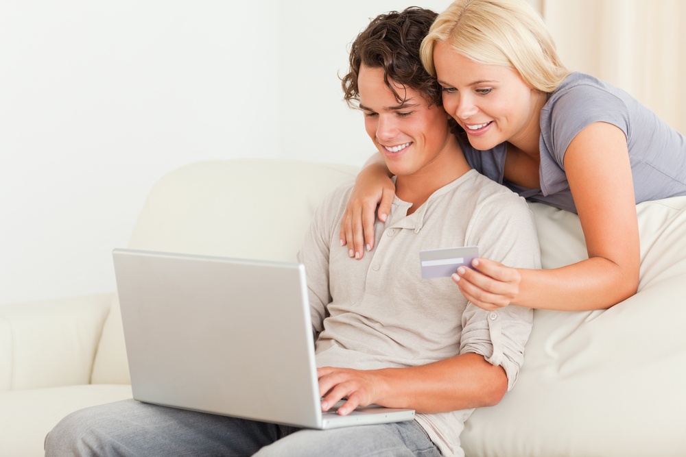 Couple shopping online in their living room